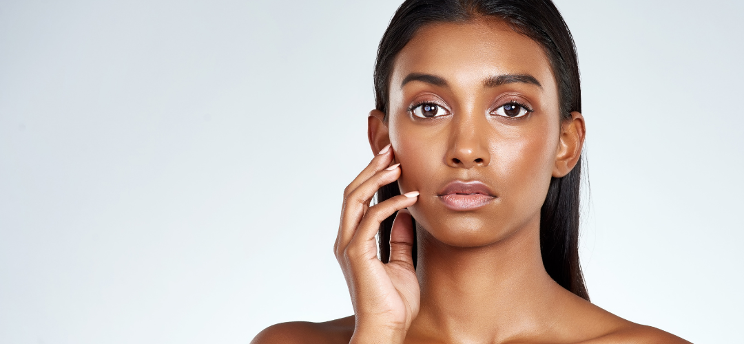 An image of a woman with her hand on her face