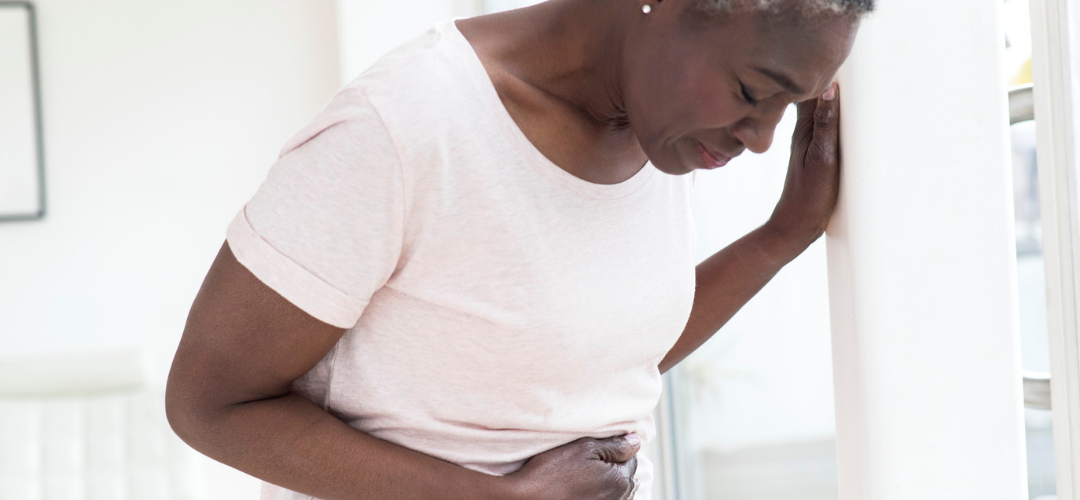 Woman leaning over in stomach pain