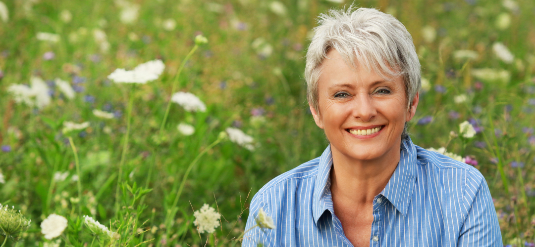 An image of an older woman in a field|