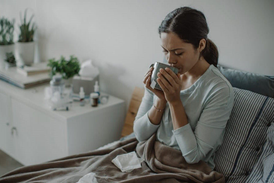 lady drinking best probiotics for antibiotics consumption when not well.