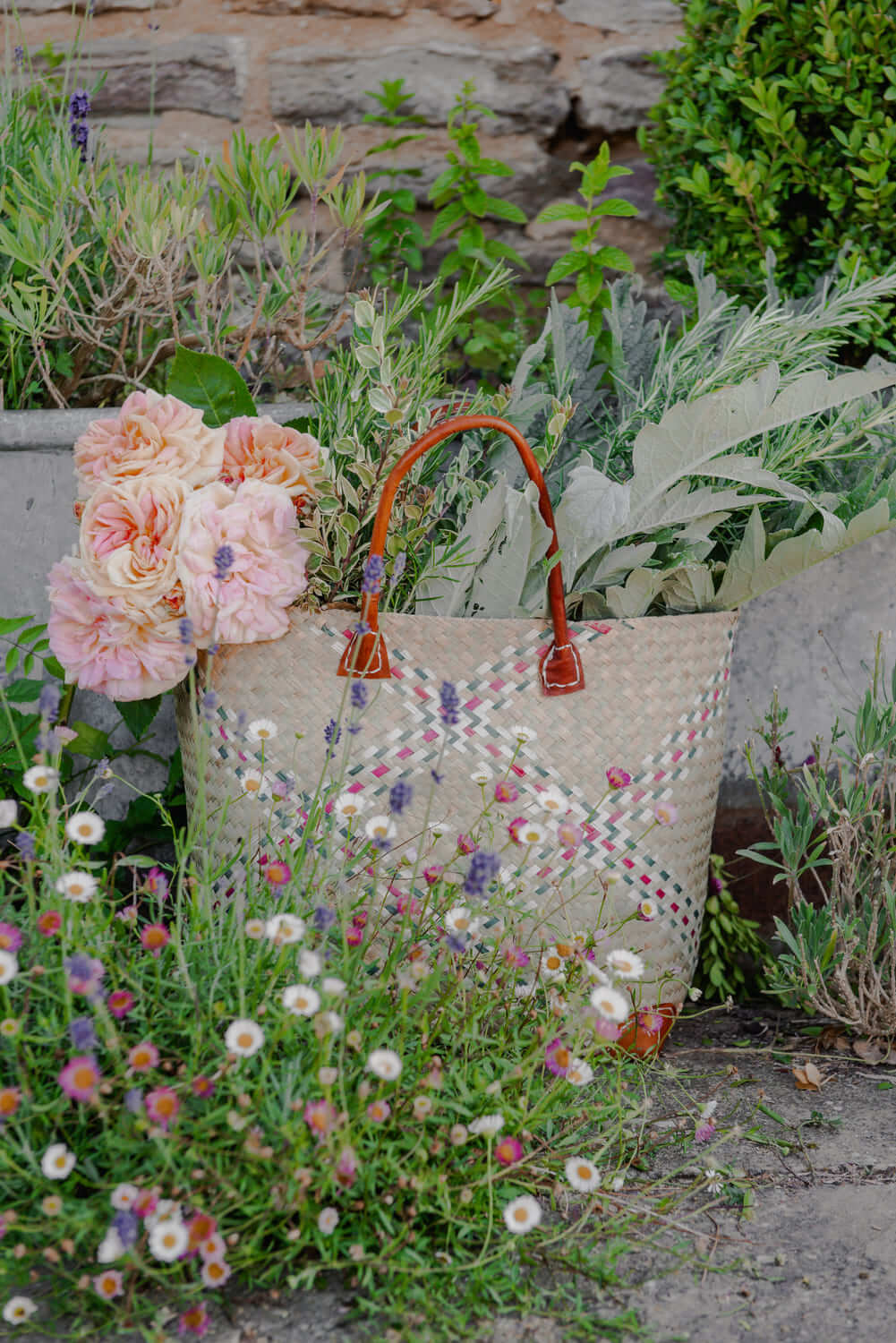 woven bag containing flowers and vegetables