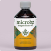 Bottle of microbz magnesium oil on a light purple background