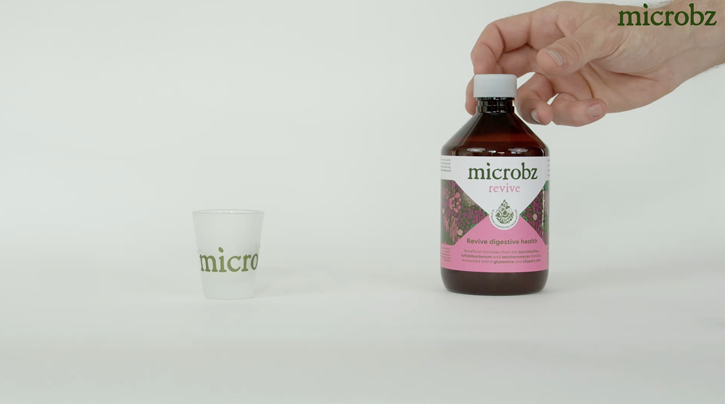 a shot glass to drink our probiotics for a healthy gut