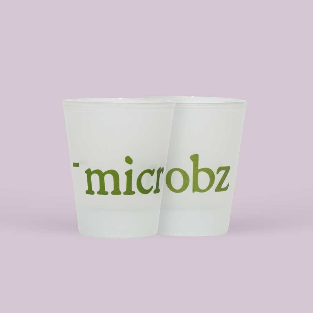 2 branded shot glasses that say microbz and a fill line indicating 15ml