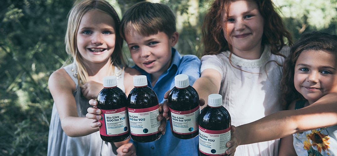 happy children smiling holding bio live probiotics