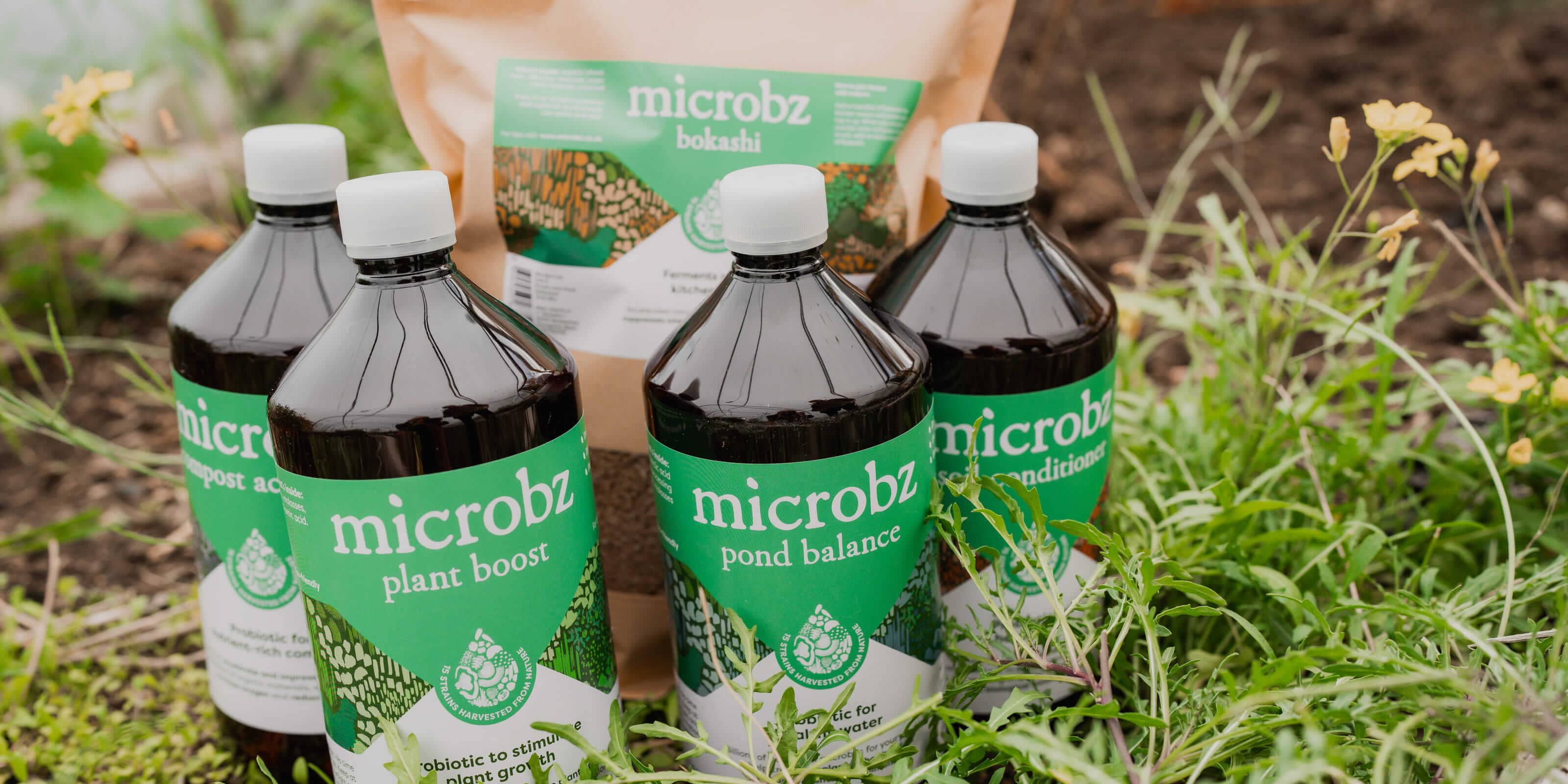 microbz plant boost, microbz pond balance, micobz bokashi in a raised garden bed. These are natural gardening products 