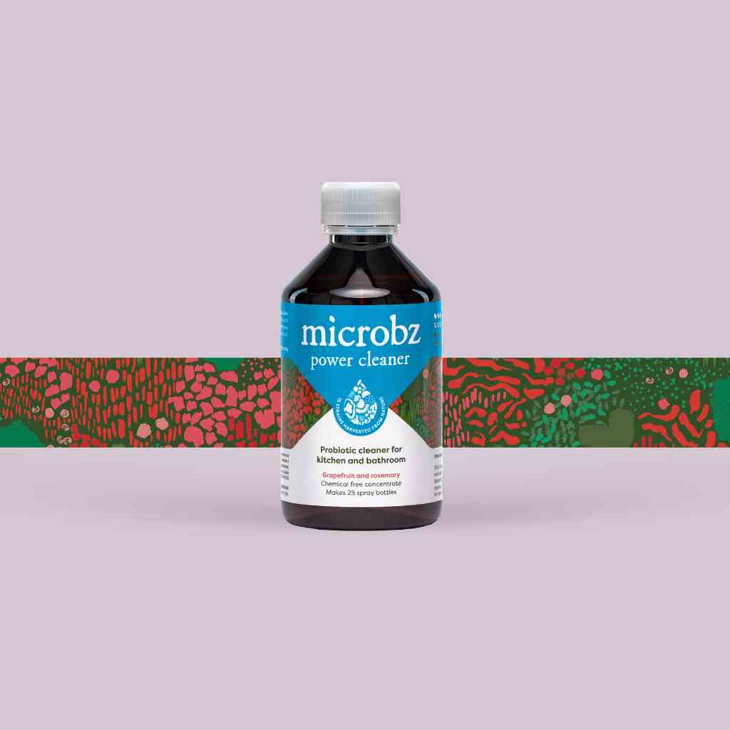 bottle of microbz living liquid probiotic for cleaning kitchens and bathrooms, with graphic illustration