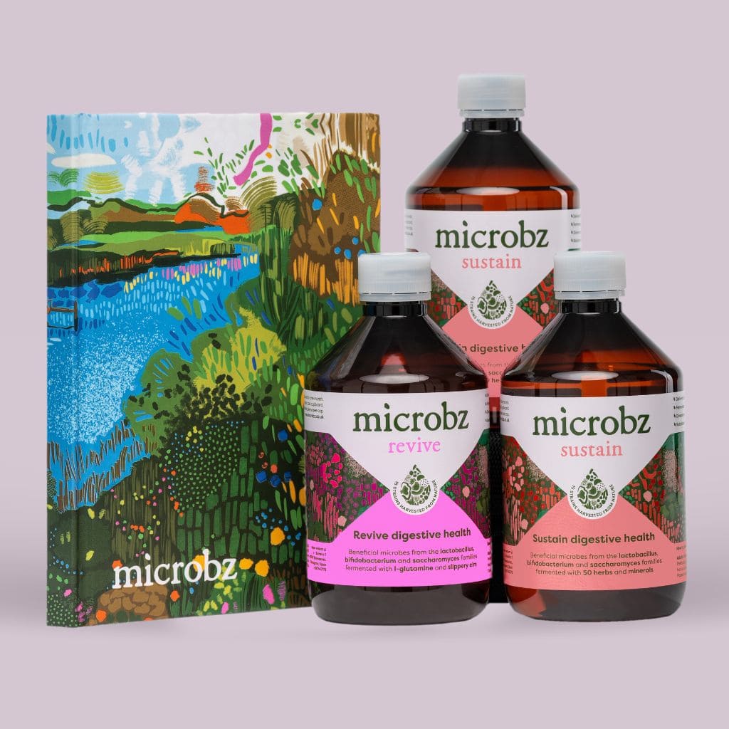 A product image with one bottle of microbz revive and two bottles of microbz sustain as well as a notebook