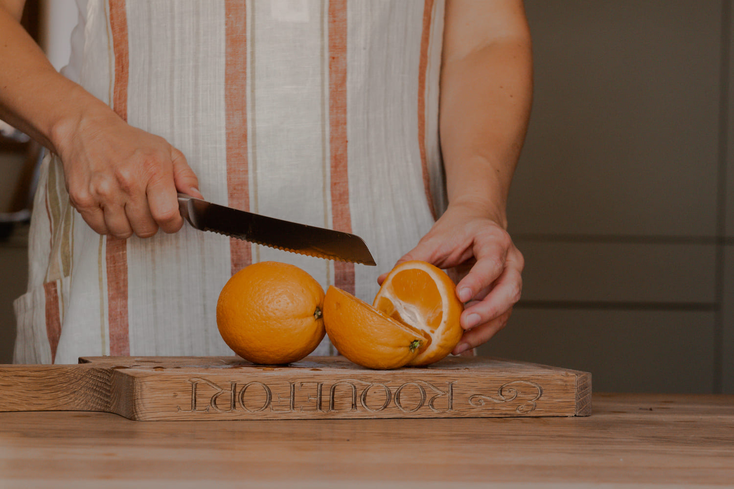slicing oranges on a wooden chopping board