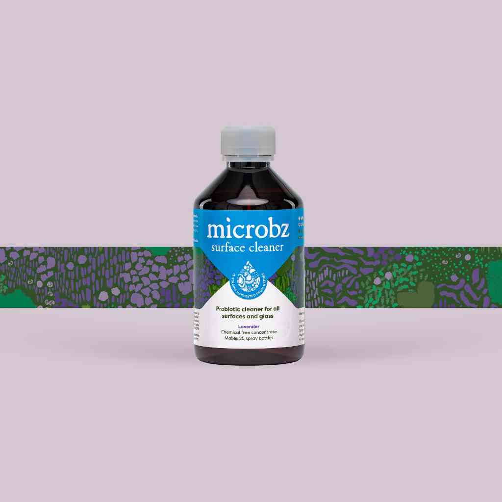 bottle of microbz living liquid probiotic for cleaning surfaces and glass, with graphic illustration